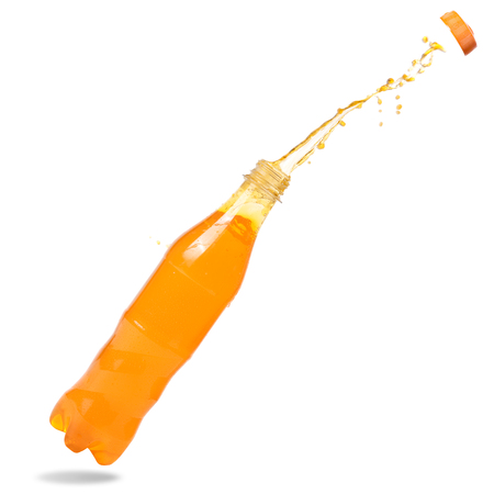 Orange juice splash out of bottle on white background.の写真素材
