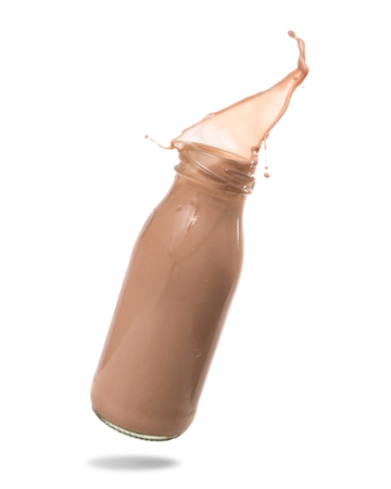 Chocolate milk splash out of bottle., Isolated on white background.の写真素材