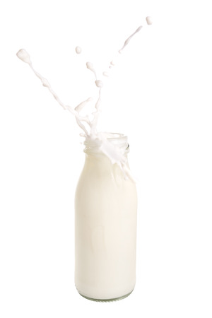 Milk splash out of bottle isolated on white background.の写真素材