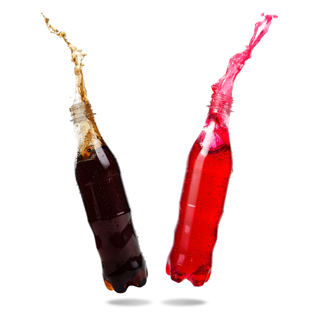 Couple cola and red soda splash out of bottle Isolated on white background.の写真素材