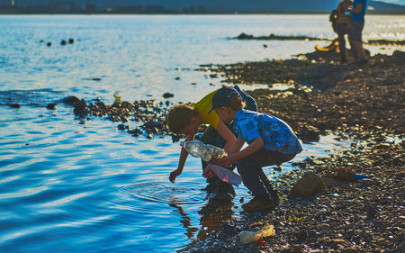 Norilsk, Russia - June 20, 2017: boys playing on the shore of the lakeのeditorial素材