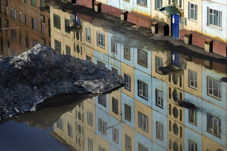 street flooded with water. Thawing snow with the arrival of springの写真素材