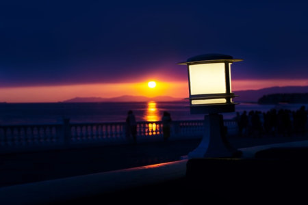 retro lantern on the waterfront at sunsetの写真素材