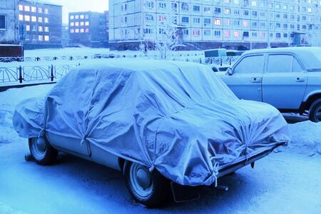 a frozen car is parked in winterの写真素材