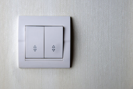 Two-key switch gray on the wall a plastic mechanical switch. Light switch installed after repair....
