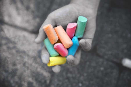 Hand holds colored chalk. Sad depressive photograph. Depression and bad mood concept.のeditorial素材