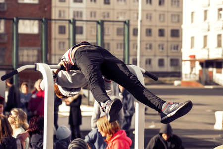 Norilsk, Russia - August, 28, 2016: Little boy doing exercise on the horizontal bar. Street workout. Childrens sport and healthy lifestyle conceptのeditorial素材