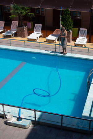 Anapa, Russia - May 1, 2020: swimming pool cleaning. a man is cleaning the pool. service careのeditorial素材
