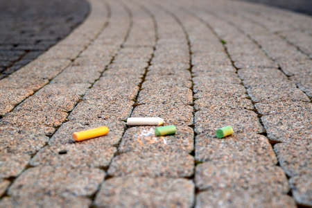 Colored chalk on playground with drawings on street.children drawing on the street. drawing lessons and creativity for kids in kindergarten, child development center. street art on asphalt, pavementの写真素材