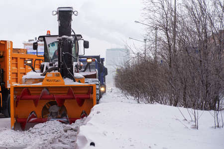 Norilsk, Russia - March 23, 2020: Snow removal machine, road cleaning vehicle, Snow plow doing snow removal after a blizzardのeditorial素材