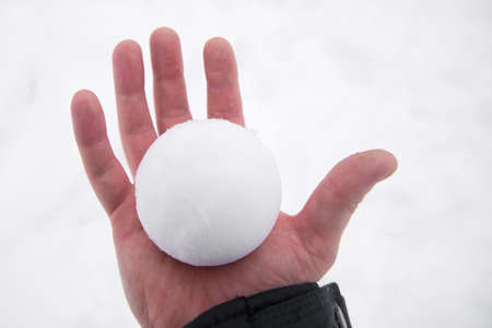 Perfect snowball in bare hand. snowball melts in bare handの写真素材