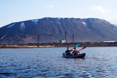 Norilsk, Russia - June 20, 2017: a guy and a girl floating on a kayak.のeditorial素材