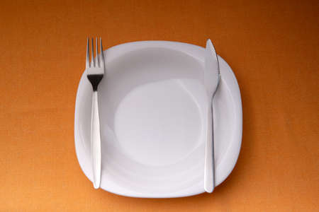 Dining etiquette - the meal is over or finished. Fork and knife signals with location of cutlery set. Top viewの写真素材
