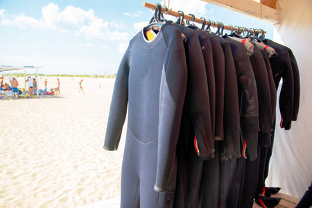 Diving suit to dry on the beach. Wetsuit on the shore. Swimming equipmentの写真素材