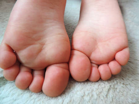 Children feet. Close-up of children wrinkled feet. Baby legs.の写真素材