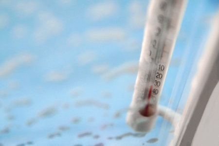 Classic mercury thermometer for measuring ambient temperature, hanging outside the window, with...