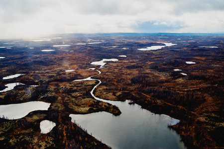 Aerial view and top view of the river in the tundra on the Taimyr Peninsula in Russia. Beautiful natural background. Blurred image, selective focusの写真素材