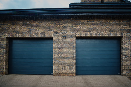 Garage Door. A double garage with blue doors at the end of a drivewayの写真素材