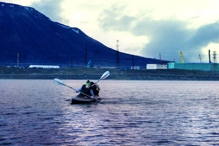 Norilsk, Russia - June 20, 2017: a guy and a girl floating on a kayakのeditorial素材