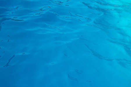 blue water wave texture background. Rippled water. Shiny purple and blue water surface.の写真素材