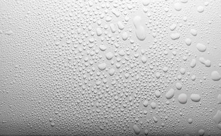 Close up of water drops on gray tone background. Abstarct black wet texture with bubbles on window glass surface or grunge. Raindrop, Realistic pure water droplets condensed for creative banner designの写真素材
