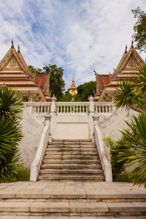 golden statue on top of hill in a thai temple at Pattayaの写真素材