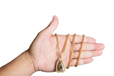 isolation on white of human hand with golden amulet