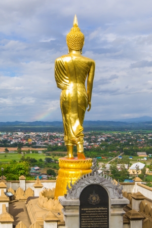 golden buddha statue under cloudy sky in thailand templeの写真素材
