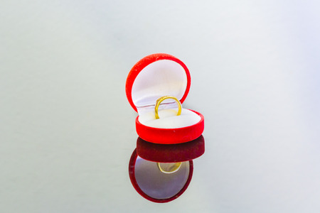 isolation on white of golden ring in red boxの写真素材