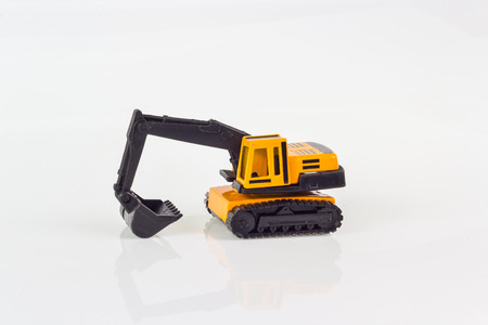miniature toy excavator isolated on whiteの写真素材