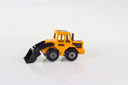 miniature toy of steer loader isolated on whiteの写真素材