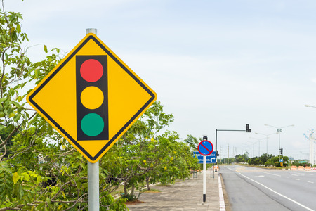 warning traffic light sign post on roadの写真素材