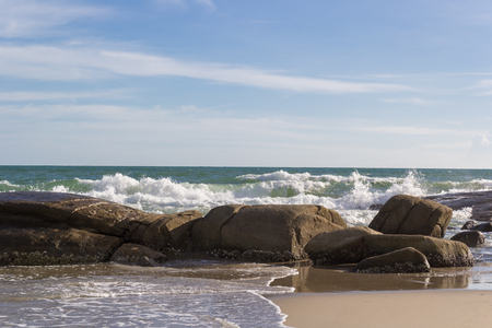 seascape with splash water over the rock under blue skyの写真素材
