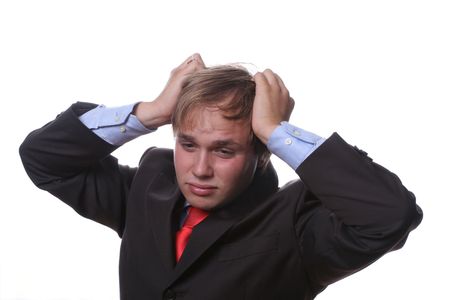 worried young businessman pulling the hairの写真素材