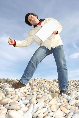 Young Man Holding White Card at the beachの写真素材