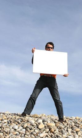 Young Man Holding White Card at the beachの写真素材