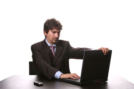 young business man working on laptop isolated on white backgroundの写真素材