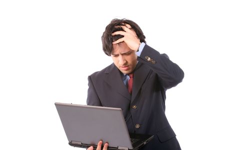 Young woried business man working with laptop, isolated on white backgroundの写真素材