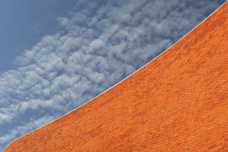 Detail of a Bricked Wall in a beautiful background blue skyの写真素材