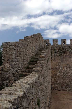 Castle wall perspective, isolated in blue sky backgroundの写真素材