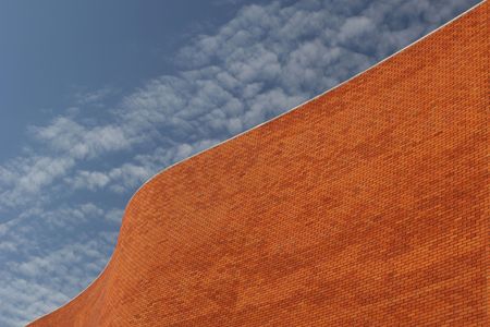 Detail of a Bricked Wall in a beautiful background blue skyの写真素材