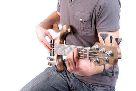 Detail of a man playing bass - focus on man's right hand