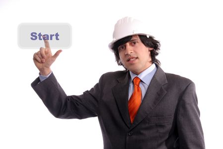 Young Engineer, presses the Start button, isolated in white backgroundの写真素材