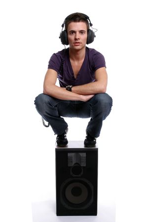 Young man with headphones, stading in a speaker, isolated in white backgroundの写真素材