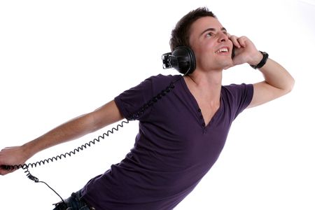 Young casual man listening to music, isolated in white backgroundの写真素材