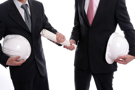 detail of two business man with safety hats, exchanging a new project, isolated in white backgroundの写真素材