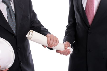 detail of two business man with safety hats, exchanging a new project, isolated in white backgroundの写真素材