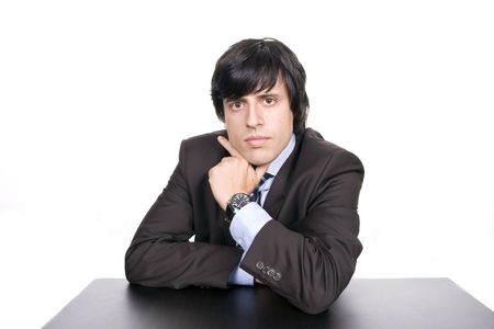 Young Businessman over a desk, full of thoughts, isolated in white backgroundの写真素材