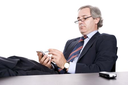 Mature Businessman working with PDA, isolated in whiteの写真素材