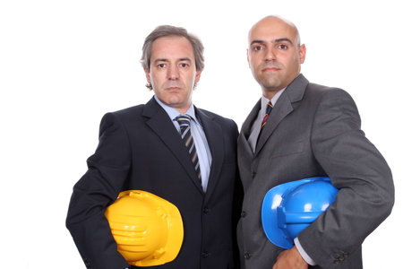 Two young businessmen posing in white background
